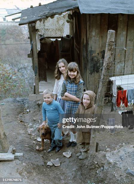 Siblings outside their ramshackle home with their dog, Pike County, Kentucky, US, 1967.