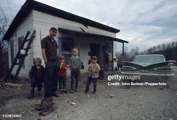 Man with his four children and a Chevrolet, Pike County, Kentucky, US, 1967.