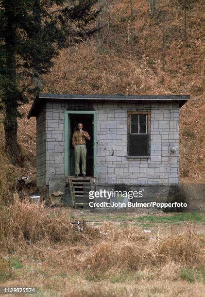 Man standing at the entrance of his house, Pike County, Kentucky, US, 1967.
