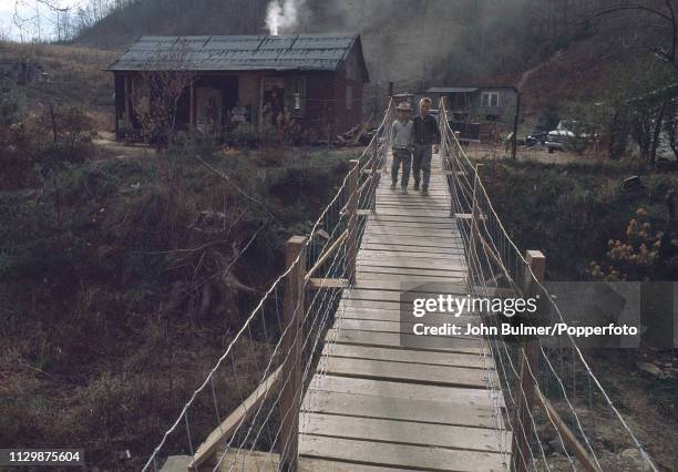 Two boys crossing a robe bridge, Pike County, Kentucky, US, 1967.