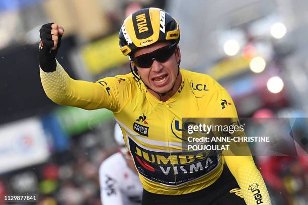 Netherlands' Dylan Groenewegen, wearing the overall leader's yellow jersey, celebrates as he crosses the finish line at the end of the 163,5km 2nd...