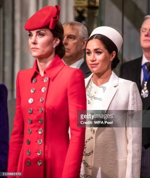 Catherine, The Duchess of Cambridge stands with Meghan, Duchess of Sussex at Westminster Abbey for a Commonwealth day service on March 11, 2019 in...
