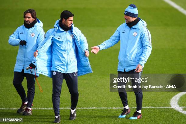 Pep Guardiola the head coach / manager of Manchester City and Mikel Arteta the assistant head coach / manager of Manchester City during the...