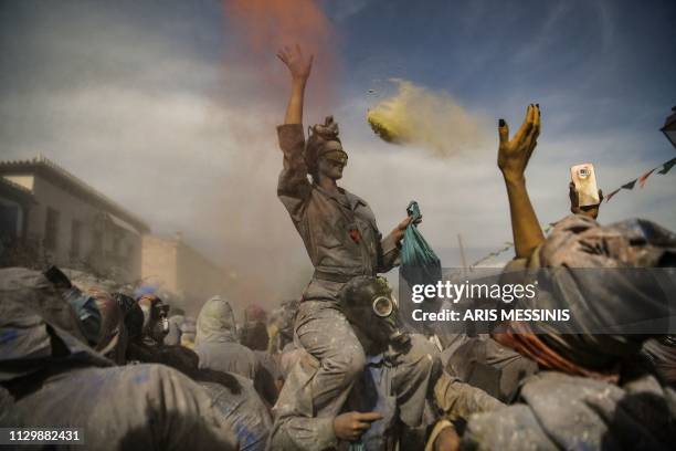 Reveller throws coloured flour as she participates in a 'flour war' during the 'Ash Monday' celebrations, a traditional festivity marking the end of...