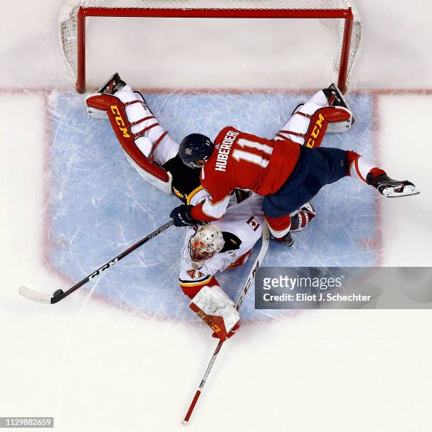 Goaltender Mike Smith of the Calgary Flames makes a stop against Jonathan Huberdeau of the Florida Panthers in a shoot at the BB&T Center on February...