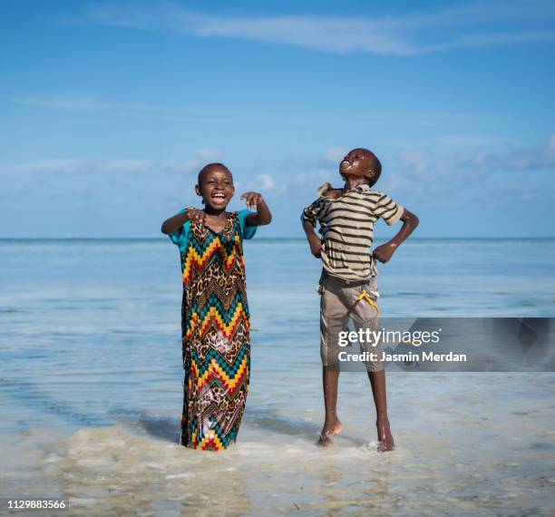 boy and girl playing on the beach - zanzibar island stock pictures, royalty-free photos & images