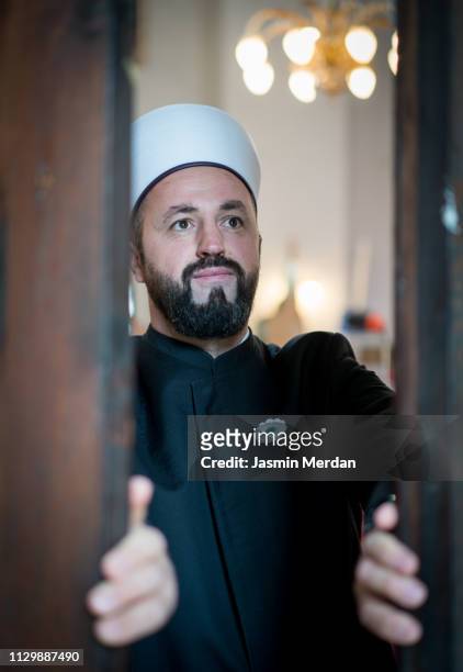 Muslim priest opening door