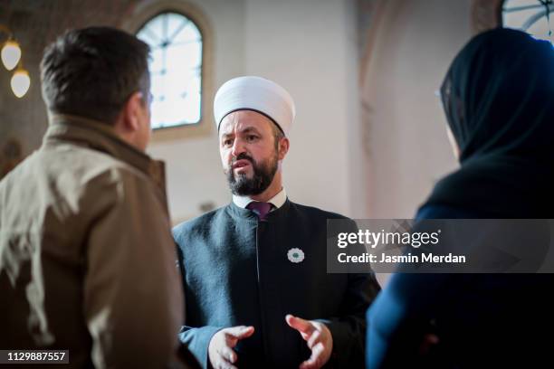 mosque man talking with people - imam stock pictures, royalty-free photos & images