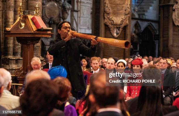 International didgeridoo player William Barton performs during the Commonwealth Day service at Westminster Abbey in London on March 11 as members of...