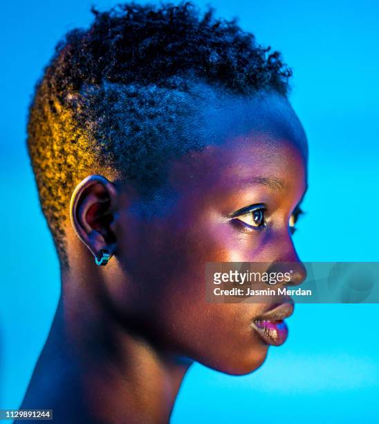 glowing neon black girl - colour image stock-fotos und bilder