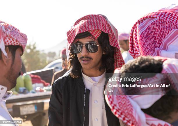 Saudi young men with keffiehs and sunglasses, Najran Province, Najran, Saudi Arabia on December 8, 2018 in Najran, Saudi Arabia.