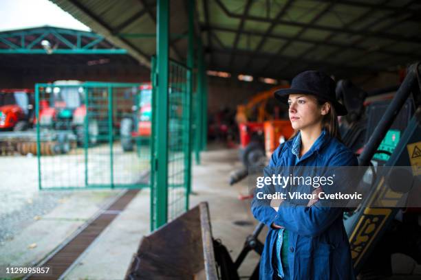 mechanic woman in farm garage - tractor repair stock pictures, royalty-free photos & images