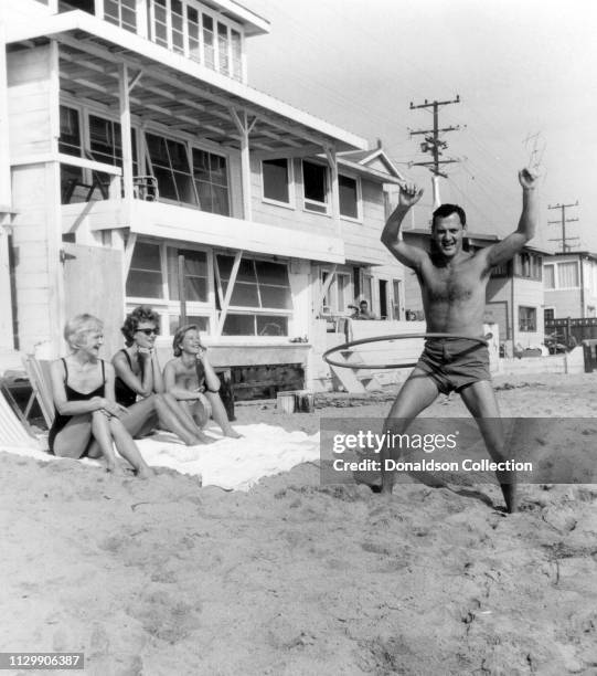 Actors Tony Randall and his wife Florence Randall with guests Dodie Heath and Barbara Bel Geddes at the beach in 1958.