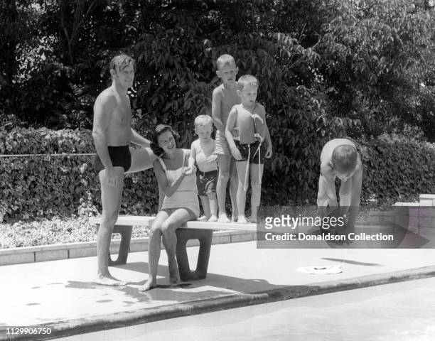 Actor Chuck Connors by the pool with his wife Elizabeth Jane Riddell Connors and their four sons Michael Connors, Jeffrey Connors, Stephen Connors,...