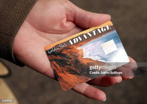 Deborah McFadden holds a sample of the new California State Electronic Benefit Transfer card July 17, 2002 in Oakland, California. On August 1,...
