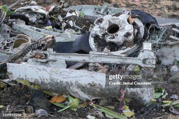 Parts of the landing gear lay in a pile after being gathered by workers during the continuing recovery efforts at the crash site of Ethiopian...