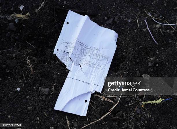 Crew check list lay in the open in the debris field just outside of the impact crater during the continuing recovery efforts at the crash site of...