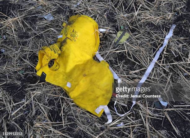 Life vest lays in the open in the debris field just outside of the impact crater during the continuing recovery efforts at the crash site of...