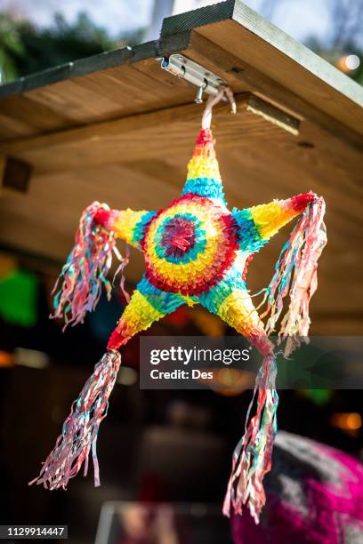 star shape pinata hanging on a market stall, geneva, switzerland - pinhata imagens e fotografias de stock