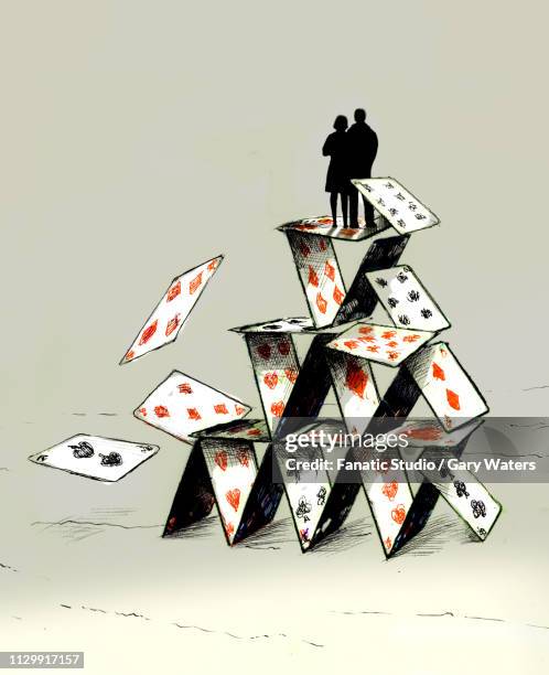 concept image of a couple standing on a tumbling house of cards depicting unstability - card house stock illustrations