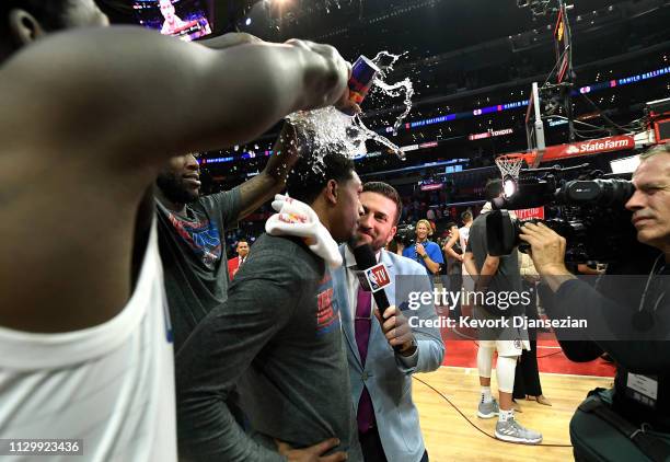 Lou Williams of the Los Angeles Clippers is doused with water by teammates Patrick Beverley and Montrezl Harrell to celebrate after getting the most...