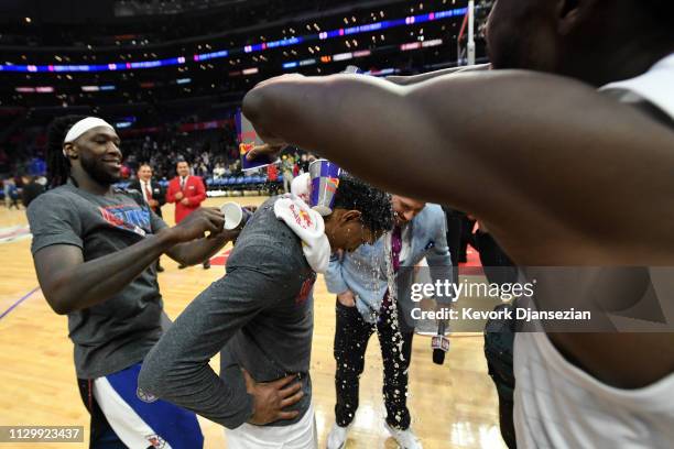 Lou Williams of the Los Angeles Clippers is doused with water by teammates Patrick Beverley and Montrezl Harrell to celebrate after getting the most...