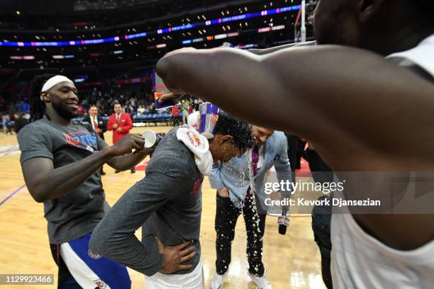 Lou Williams of the Los Angeles Clippers is doused with water by teammates Patrick Beverley and Montrezl Harrell to celebrate after getting the most...