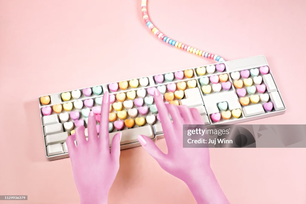 Digital illustration of hands typing on a candy keyboard