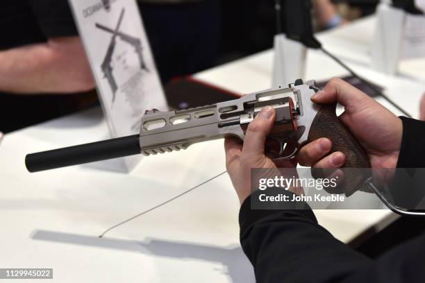 Visitor holds a Wilson revolver pistol hand gun at the Great British Shooting Show at NEC Arena on February 15, 2019 in Birmingham, England. The show...