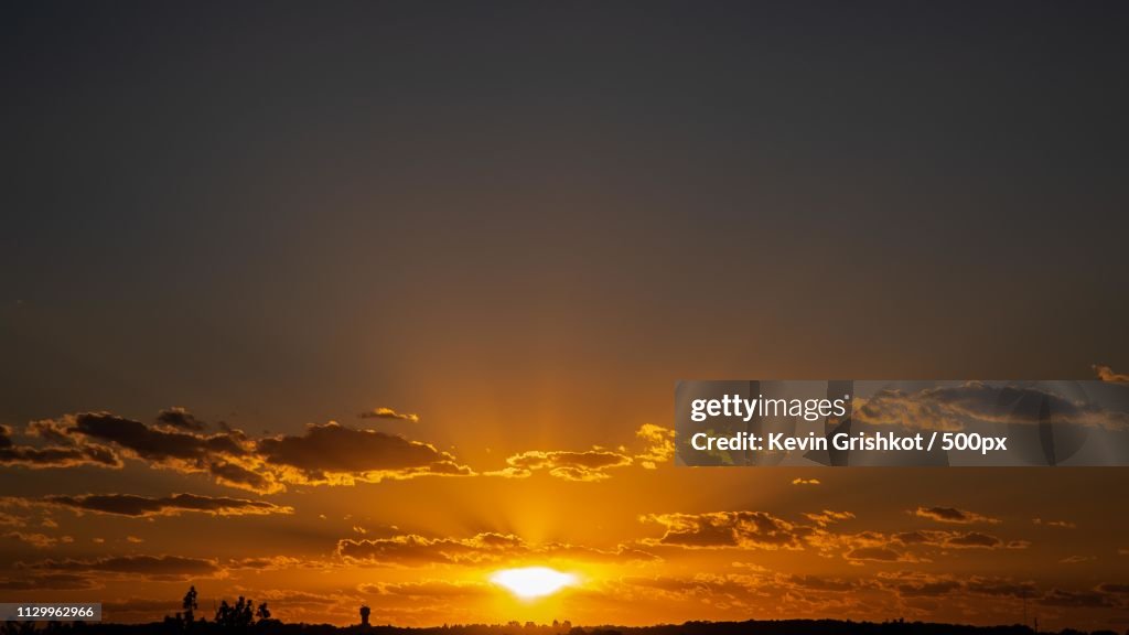 Orange sunset over low over horizon
