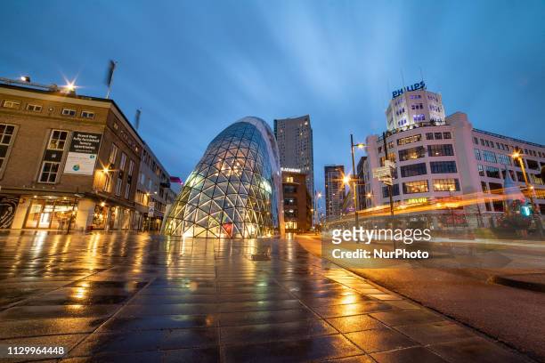 Evening and night view of Eindhoven city center with an example of modern futuristic architecture in Europe, De Blob or de Bubble, the underground...