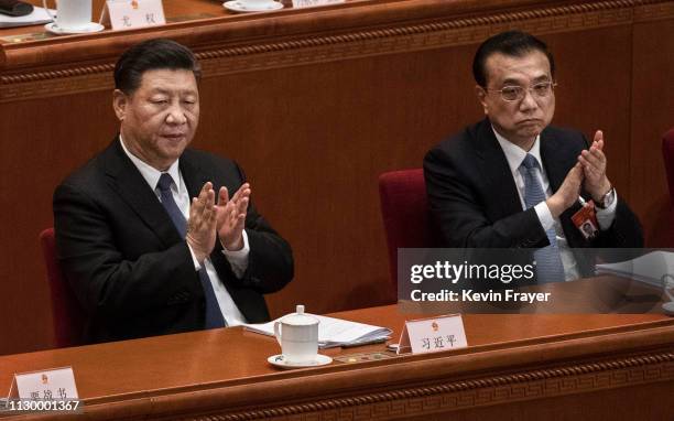 Chinese President Xi Jinping, left, and Prime Minister Li Keqiang applaud during the third plenary session of the National People's Congress at The...