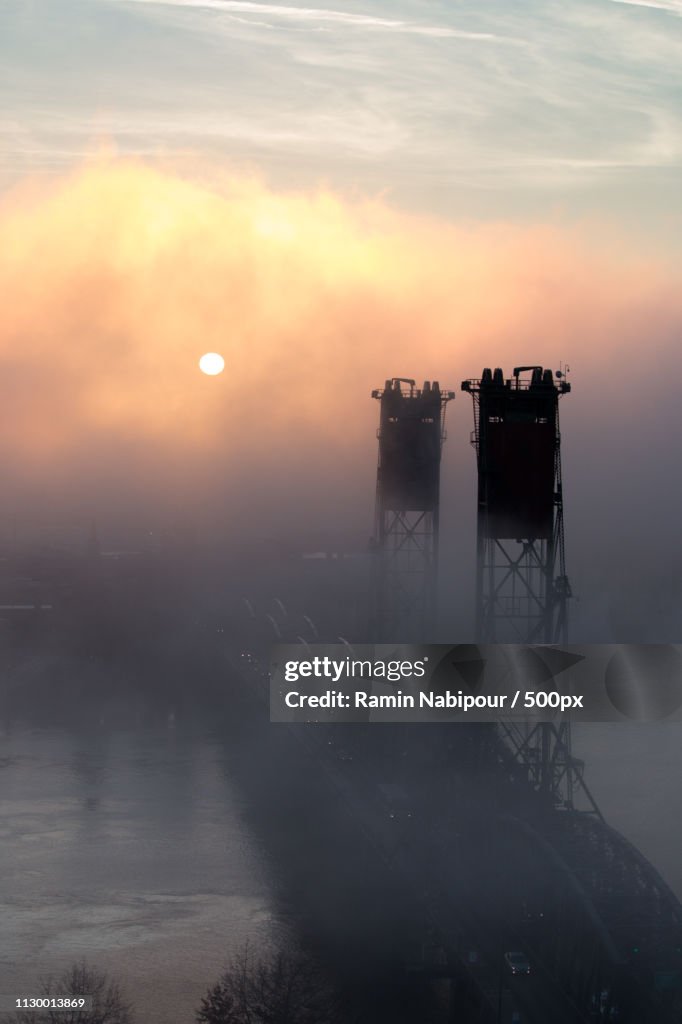 Bridge in fog at sunrise