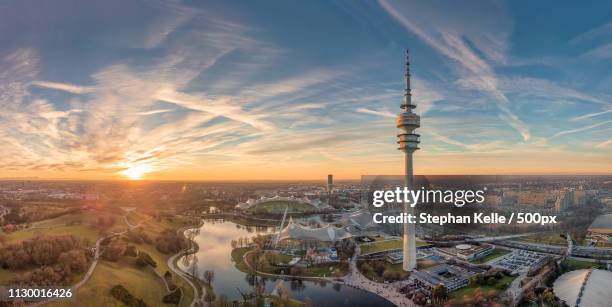 sunset above olympiapark, munich , germany - olympiapark stock pictures, royalty-free photos & images