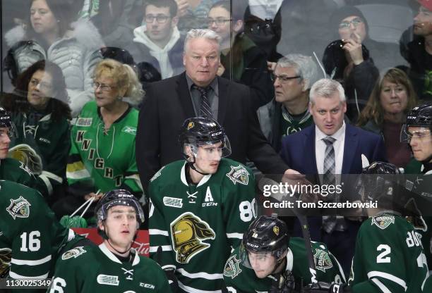 Head coach Dale Hunter of the London Knights and assistant coach Rick Steadman look on from behind the bench during OHL game action against the...