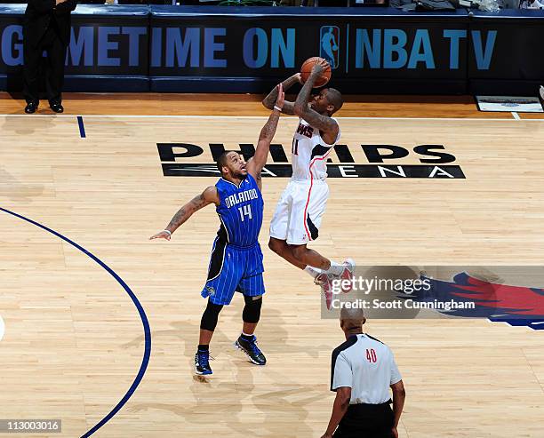 Jamal Crawford of the Atlanta Hawks puts the game away by hitting a three-point shot against Jameer Nelson of the Orlando Magic in Game Three of the...
