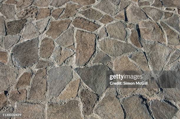 brown and grey cobblestone pathway - steinterrasse stock-fotos und bilder