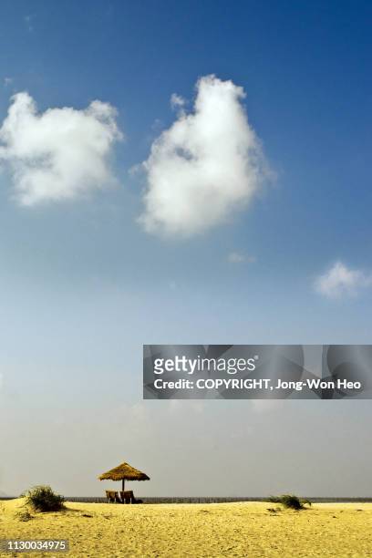 a beach parasol under the pretty cloud in the blue sky - jeollanam do stock pictures, royalty-free photos & images