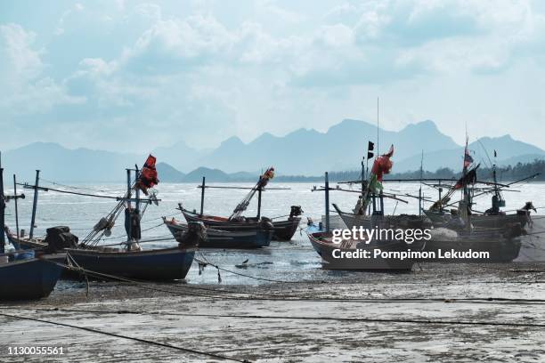 local boat on the beach with mountain background - denia fotografías e imágenes de stock