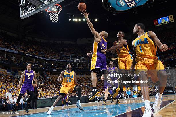 Derek Fisher of the Los Angeles Lakers shoots against Chris Paul of the New Orleans Hornets in Game Three of the Western Conference Quarterfinals in...