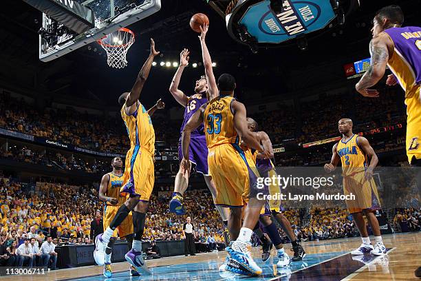 Pau Gasol of the Los Angeles Lakers shoots against Carl Landry of the New Orleans Hornets in Game Three of the Western Conference Quarterfinals in...