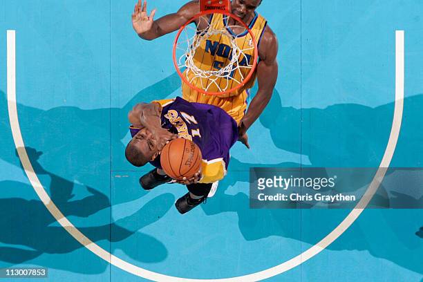 Andrew Bynum of the Los Angeles Lakers shoots the ball over Emeka Okafor of the New Orleans Hornets in Game Three of the Western Conference...