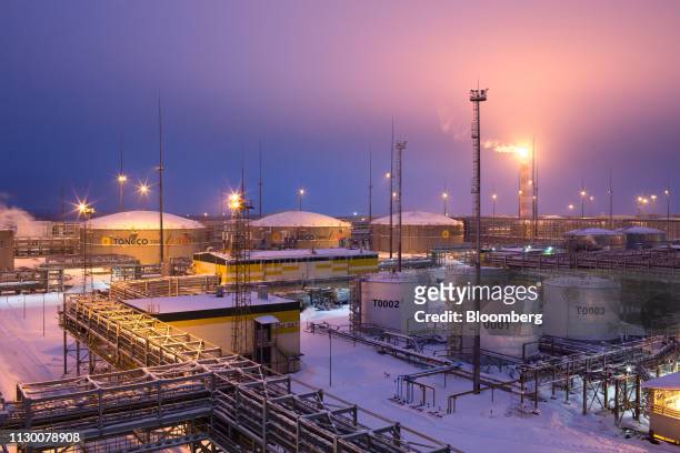 Flare stack burns beyond oil storage tanks at the Taneco Oil Refining and Petrochemical complex, operated by Tatneft PJSC, in Nizhnekamsk, Tatarstan,...