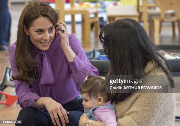 Britain's Catherine, Duchess of Cambridge meets children and parents as she visits the Henry Fawcett Children's Centre in London on March 12, 2019....