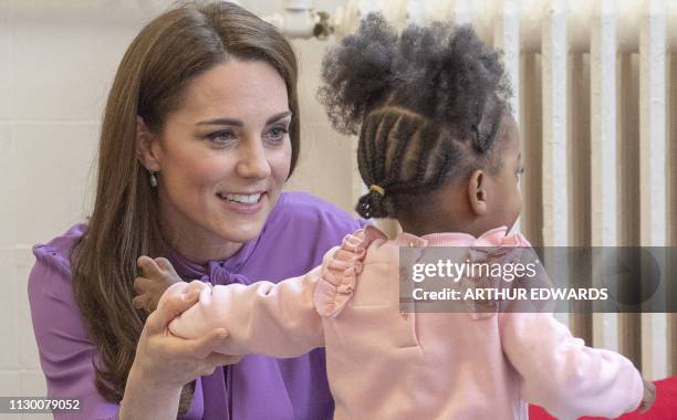 Britain's Catherine, Duchess of Cambridge meets children while she visits the Henry Fawcett Children's Centre in London on March 12, 2019. The...