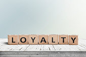 Loyalty sign on a wooden table in bright daylight