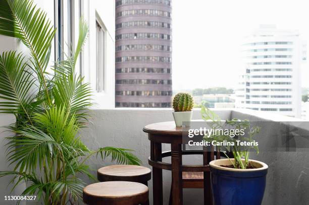 apartment balcony table with plants - vintage singapore stock pictures, royalty-free photos & images