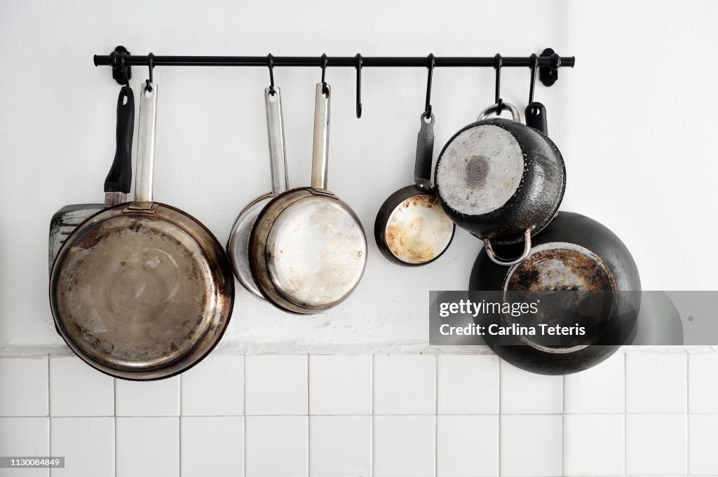 Pots and pans hanging on a kitchen wall