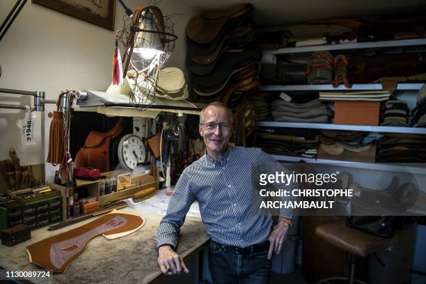 French luxury brand Hermes' saddler Laurent Goblet poses at his workshop at the Hermes saddlery in Paris on March 11, 2019. - Since 1880, Hermes has...