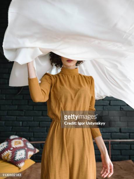 young woman holding laundry - hidden secret stock pictures, royalty-free photos & images